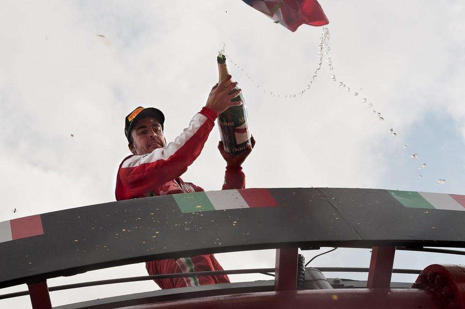 Why do Formula 1 drivers spray champagne over the crowd?